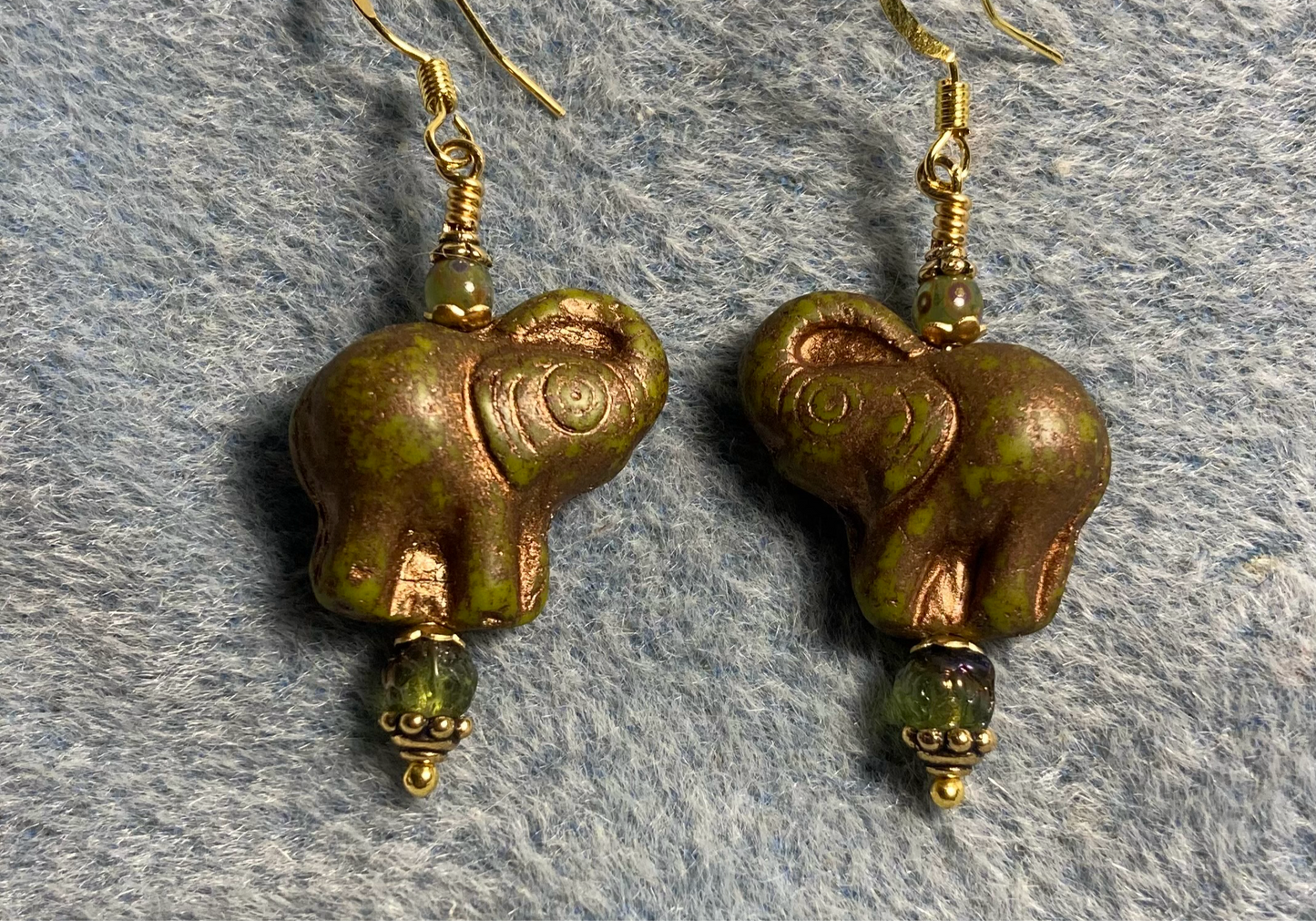 Opaque olive green (with gold inlay) Czech glass elephant bead earrings adorned with olive green Czech glass beads.