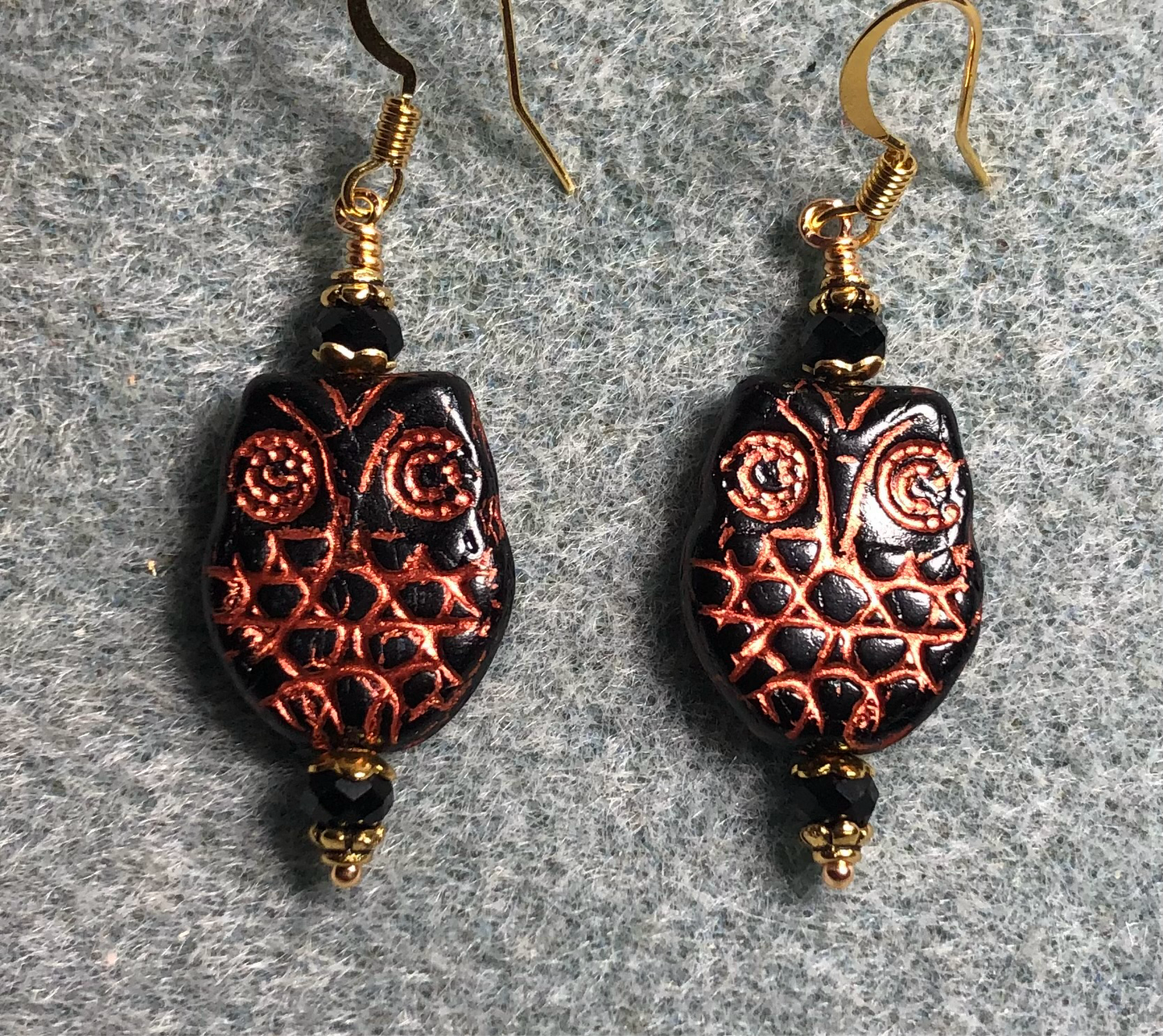 Black (with copper wash) Czech glass owl bead earrings adorned with black Chinese crystal beads.