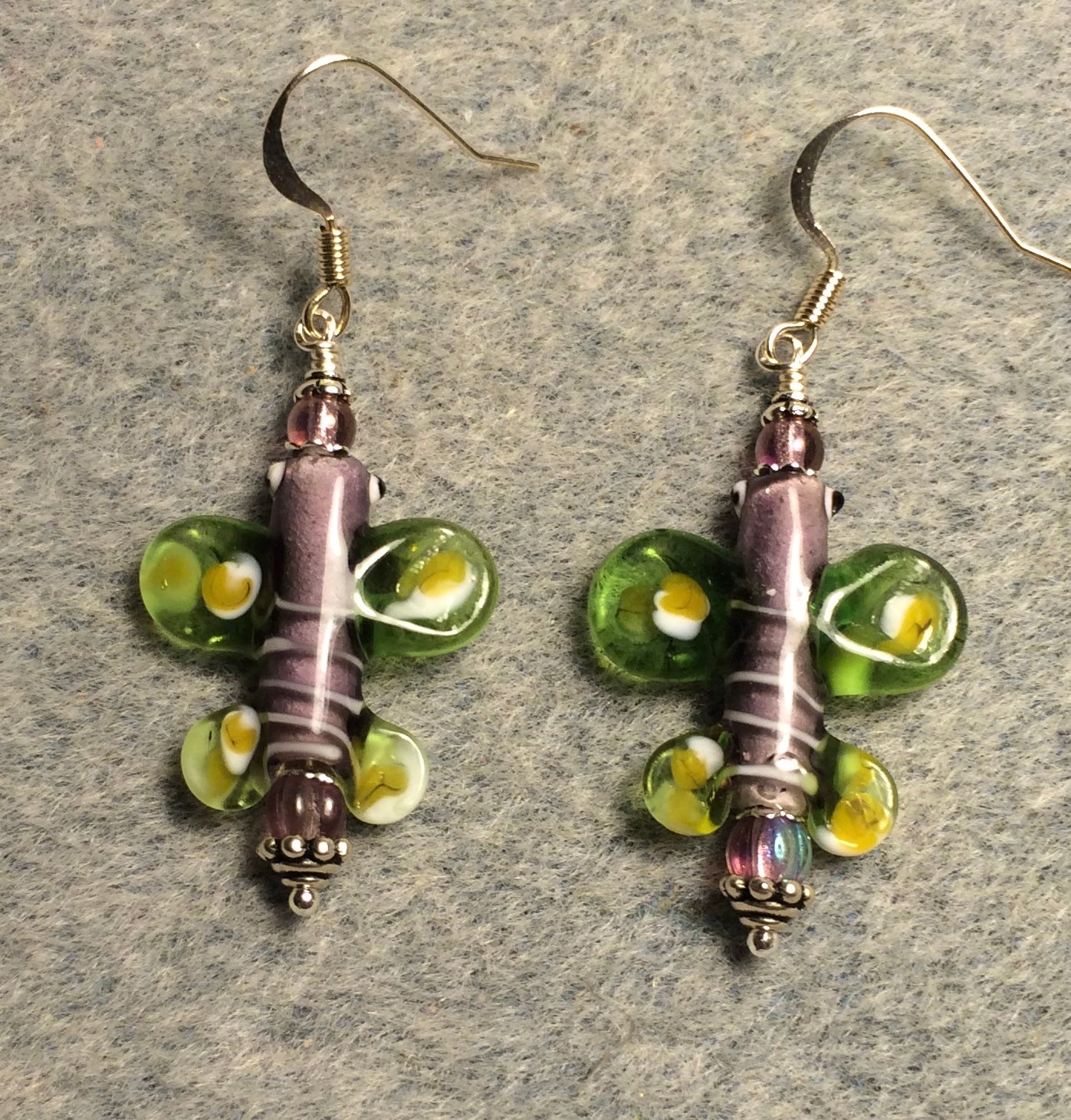 Violet and olive green lamp work butterfly bead earrings adorned with violet Czech glass beads.