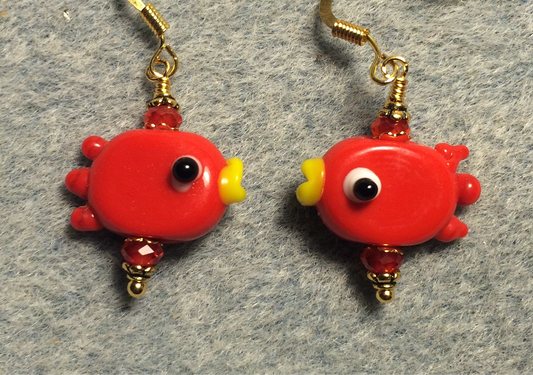 Opaque red lamp work fish bead earrings adorned with red Chinese crystal beads.