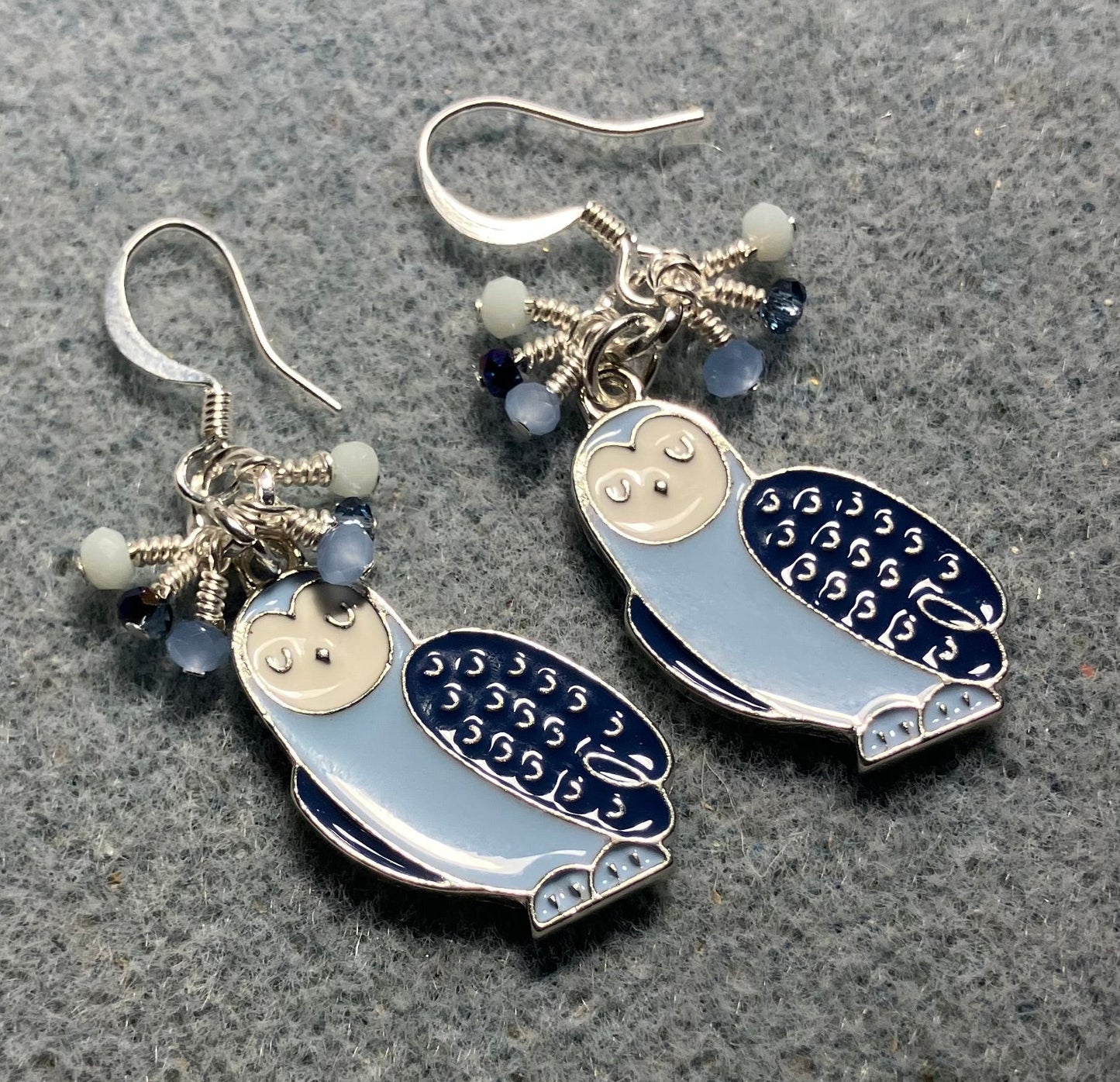 Dark blue, light blue, and white enamel owl charm earrings adorned with tiny dangling dark blue, light blue, and white Chinese crystal beads.