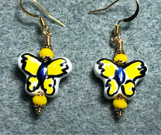 Yellow and purple ceramic butterfly bead earrings adorned with yellow Chinese crystal beads.