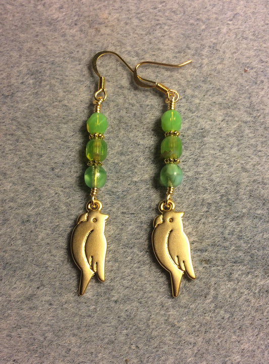 Gold parrot charm earrings adorned with lime green Czech glass beads