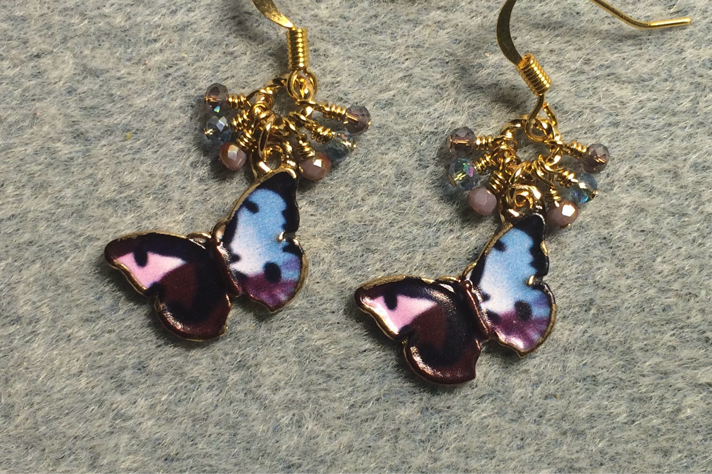 Purple and light blue enamel butterfly charm earrings adorned with tiny dangling purple and light blue Chinese crystal beads.