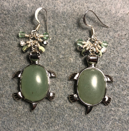 Large silver and light green aventurine gemstone turtle charm earrings adorned with small dangling light green and silver Czech glass beads.