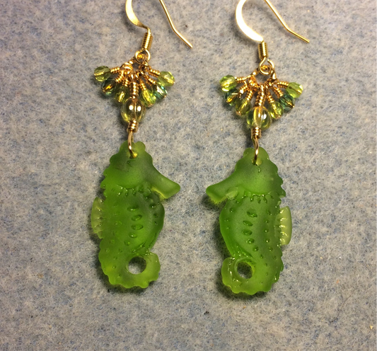 Olive green sea glass seahorse pendant bead earrings adorned with olive green Czech glass beads and small dangling olive green Czech glass beads.