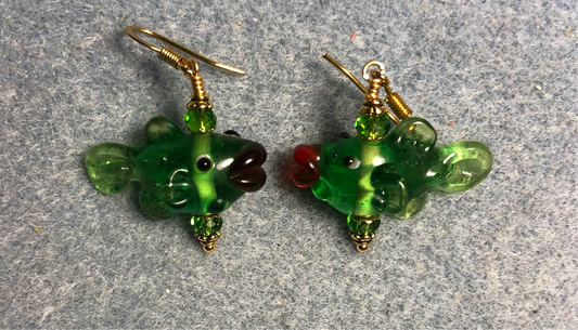 Emerald green lamp work fish bead earrings adorned with emerald green Chinese crystal beads.