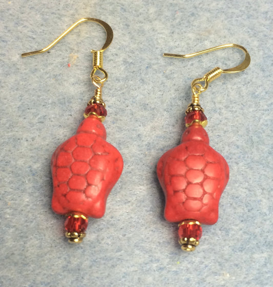Red howlite turtle bead earrings adorned with red Chinese crystal beads.