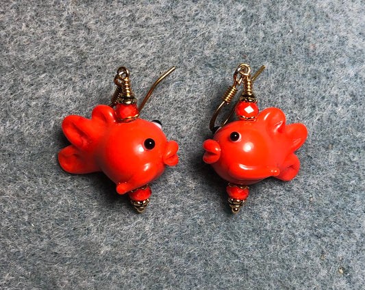Orange lamp work fish bead earrings adorned with orange Chinese crystal beads.