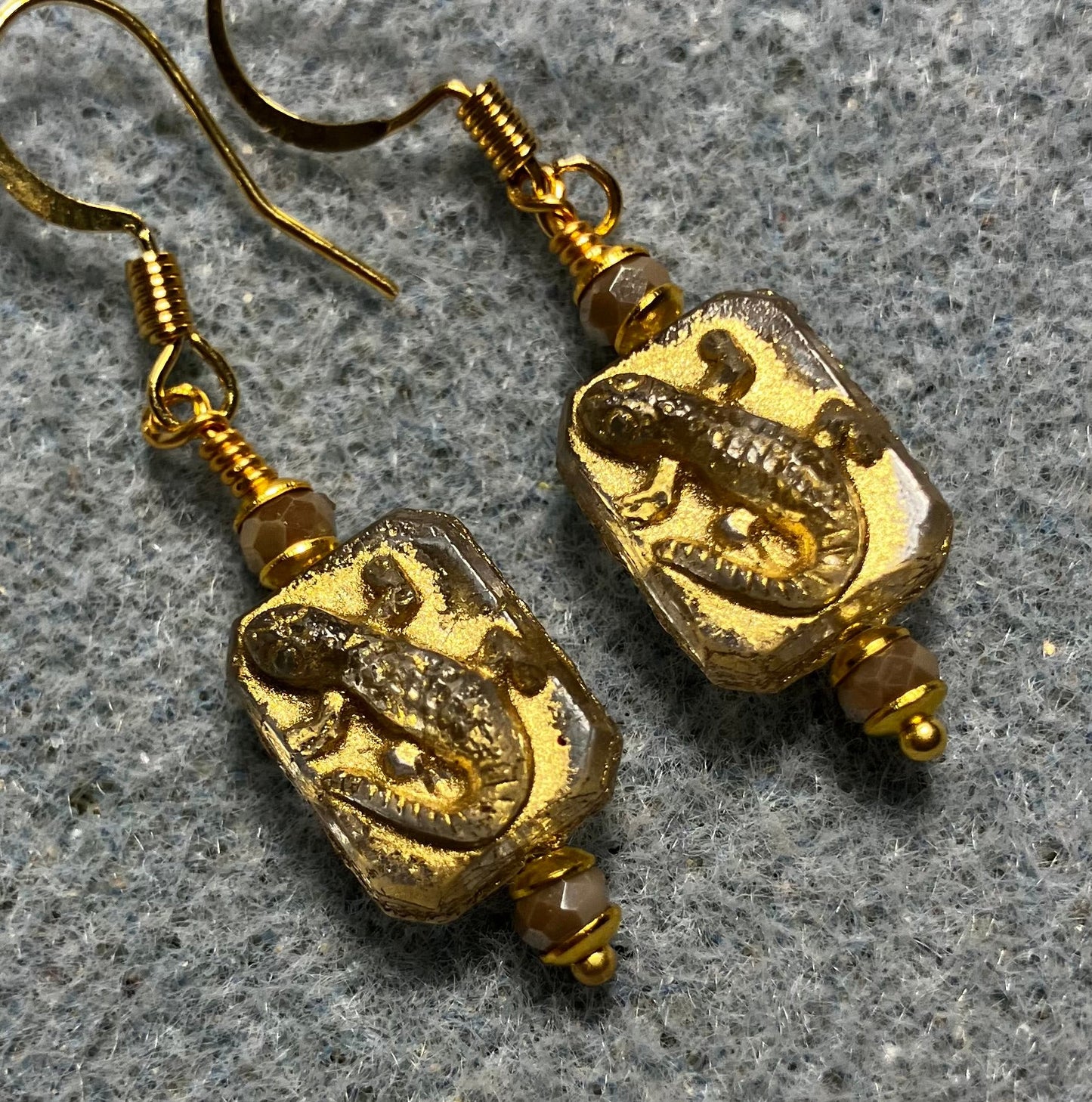Small gray and gold Czech glass lizard bead earrings adorned with gray Chinese crystal beads.