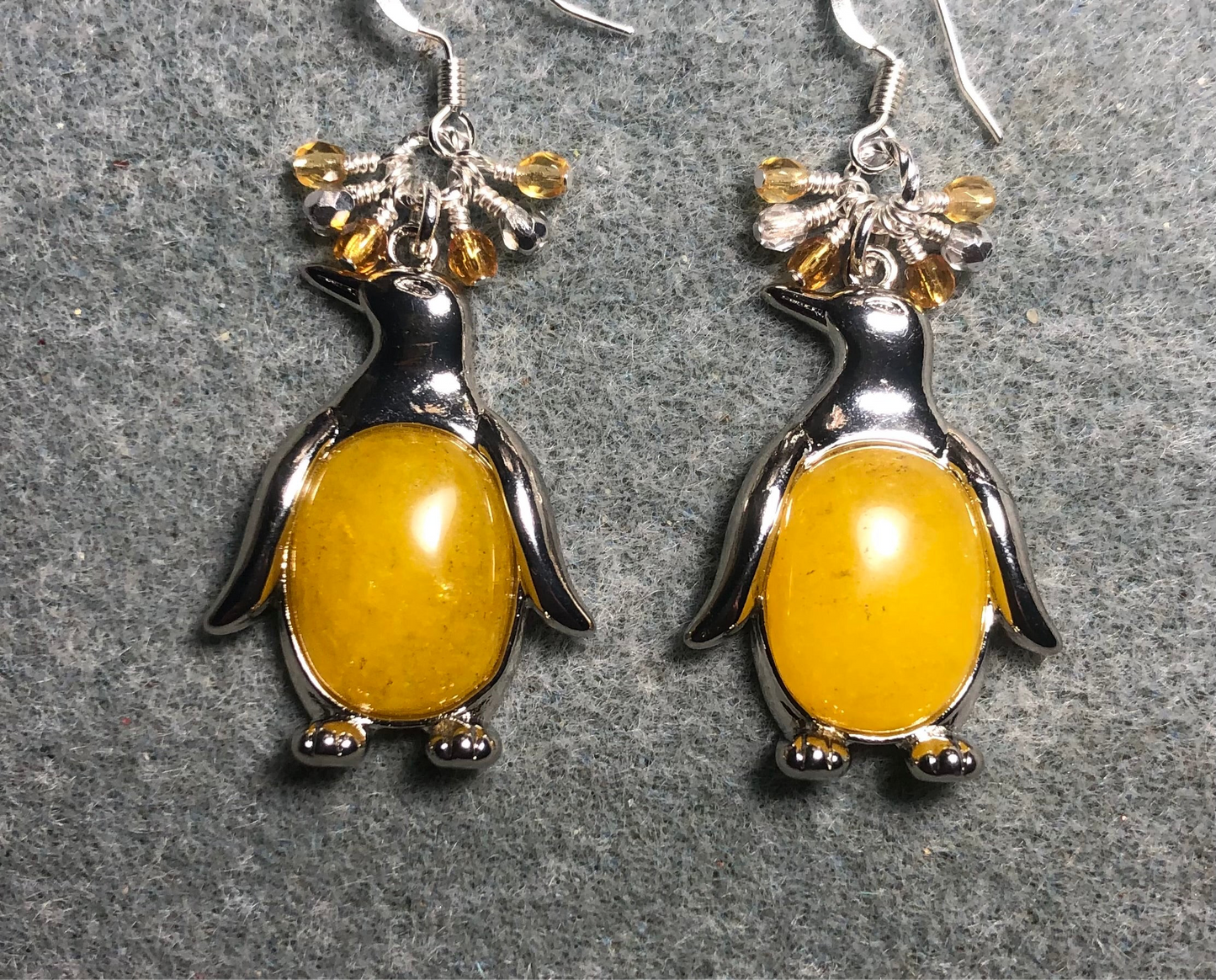 Large silver and yellow flame jasper gemstone penguin charm earrings adorned with small dangling amber and silver Czech glass beads.