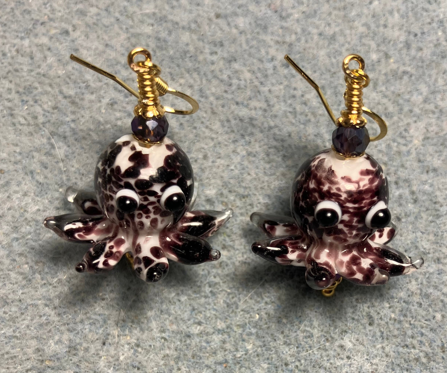 Dark purple and white mottled lamp work octopus bead earrings adorned with dark purple Chinese crystal beads.