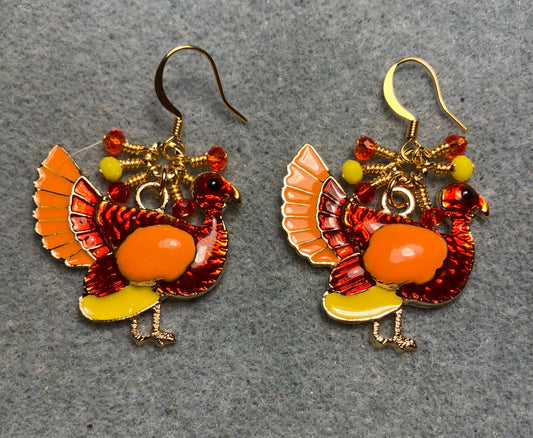 Red, orange, and yellow enamel turkey charm earrings adorned with small dangling red, orange, and yellow Chinese crystal beads.