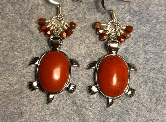 Large silver and dark orange flame jasper gemstone turtle charm earrings adorned with small dangling dark orange Czech glass beads.