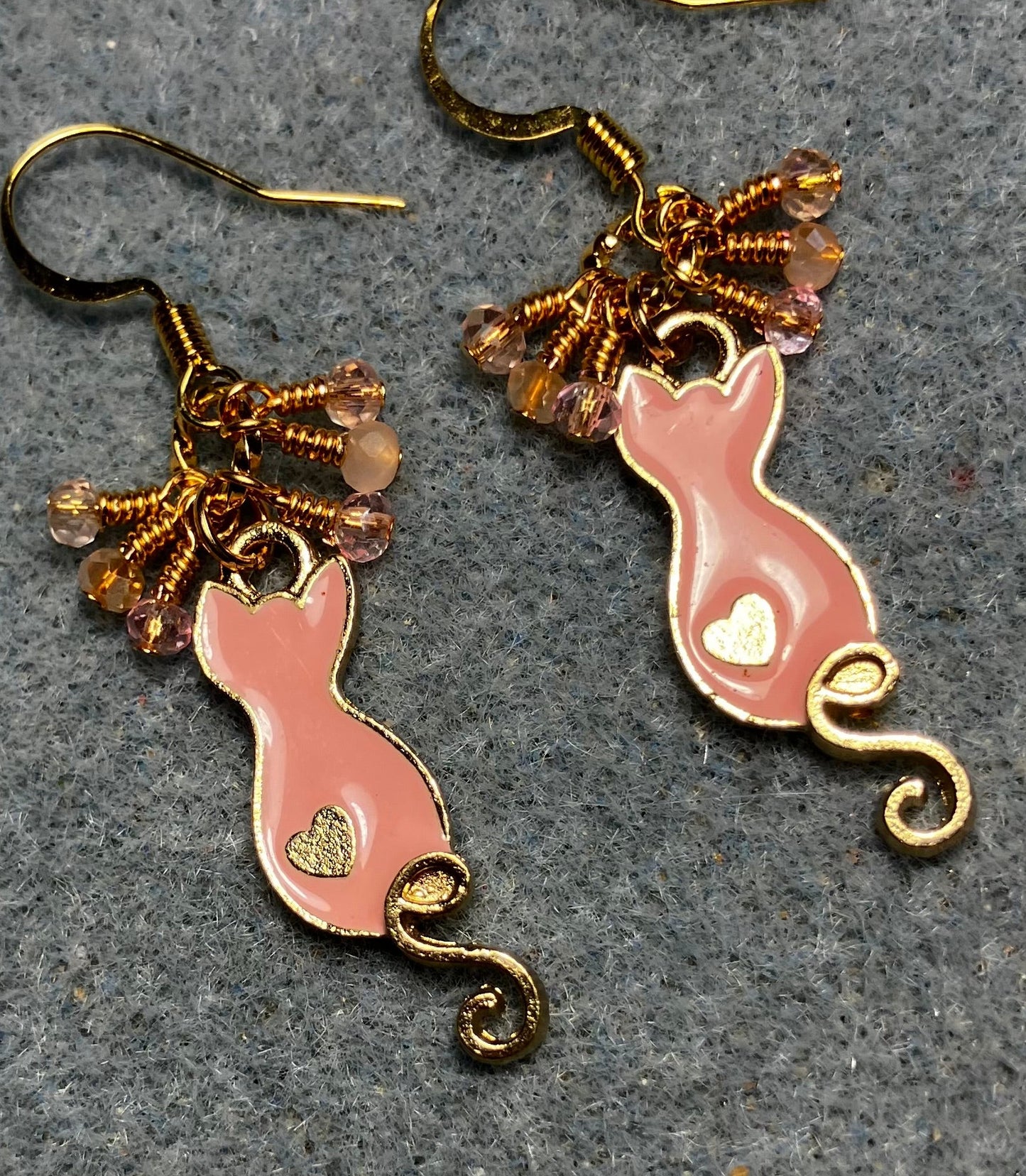 Small peach and gold enamel curly tailed cat charm earrings adorned with tiny dangling peach and pink Chinese crystal beads.