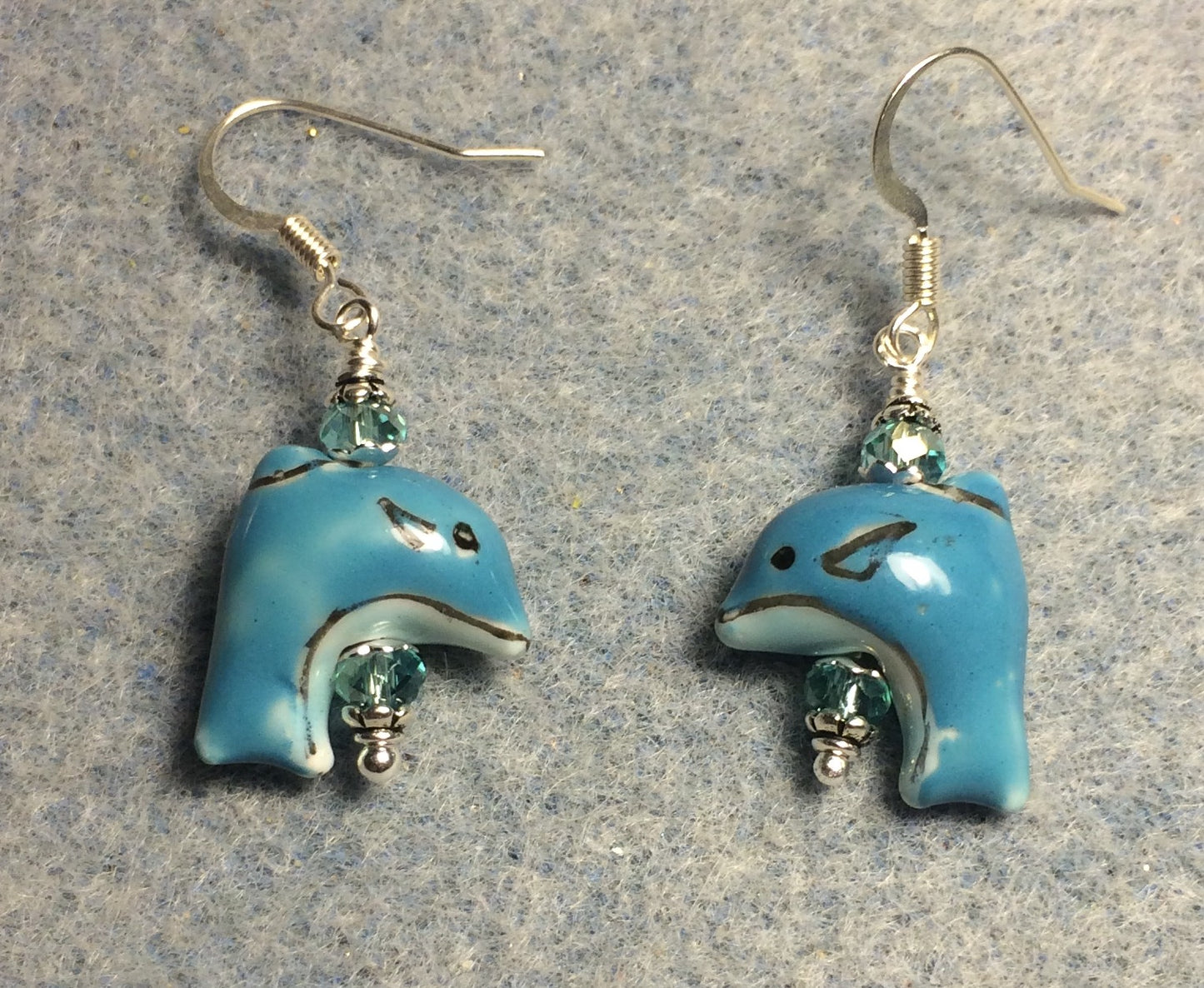 Small turquoise ceramic dolphin bead earrings adorned with turquoise Chinese crystal beads.