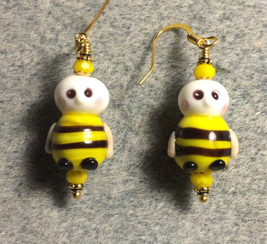 Black, yellow, and white lamp work striped honeybee bead earrings adorned with yellow Chinese crystal beads.