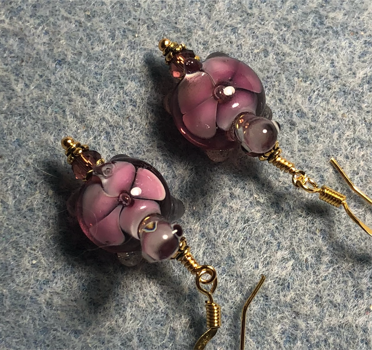 Violet and pink lamp work turtle bead earrings adorned with violet Chinese crystal beads.