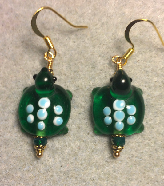 Dark green with blue spots lamp work turtle bead earrings adorned with dark green Chinese crystal beads.