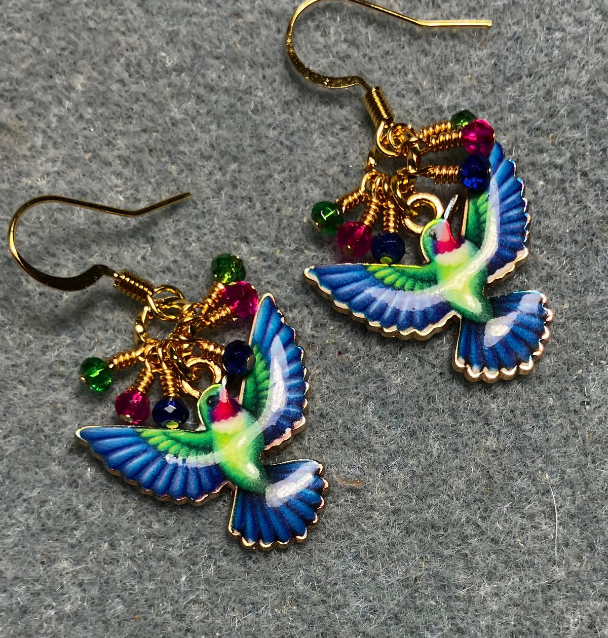 Blue, hot pink, and green enamel hummingbird charm earrings adorned with tiny dangling blue, hot pink, and green Chinese crystal beads.