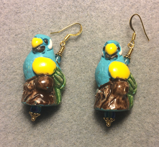 Large turquoise, yellow, and green ceramic parrot bead earrings adorned with turquoise Czech glass beads.