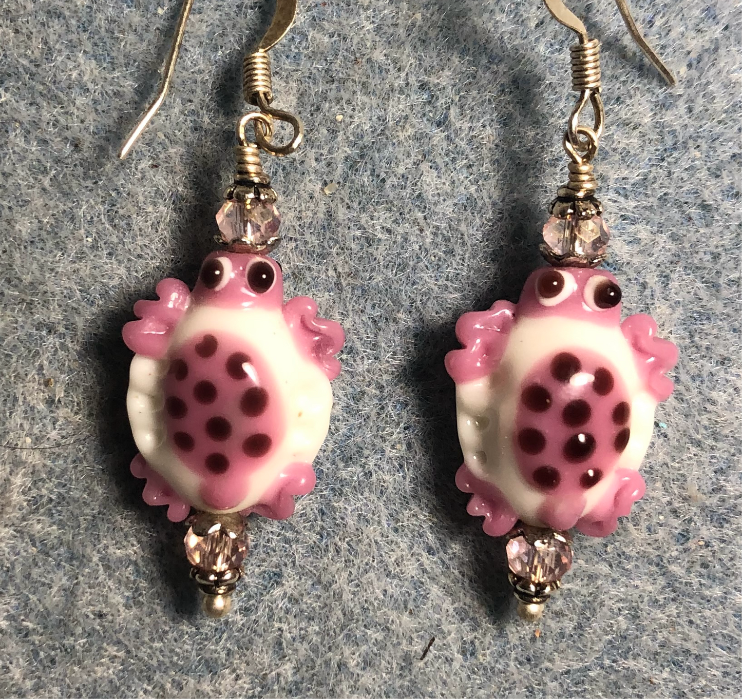 Pink and white lamp work spotted turtle bead earrings adorned with pink Chinese crystal beads.