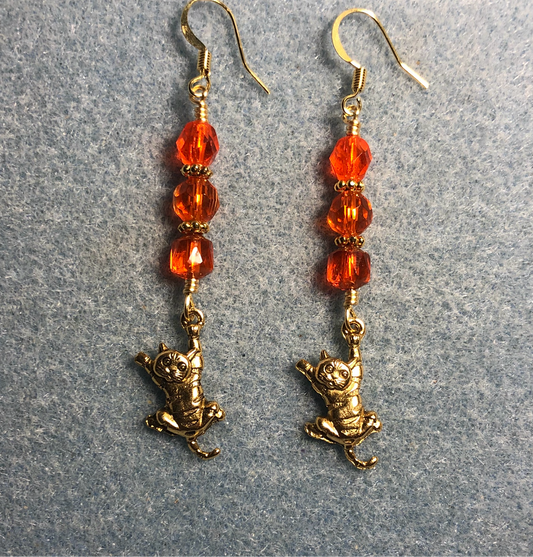 Gold tabby cat charm earrings adorned with orange Czech glass beads