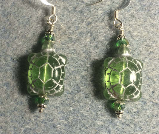 Translucent light green (with silver inlay) Czech glass turtle bead earrings adorned with light green Chinese crystal beads.