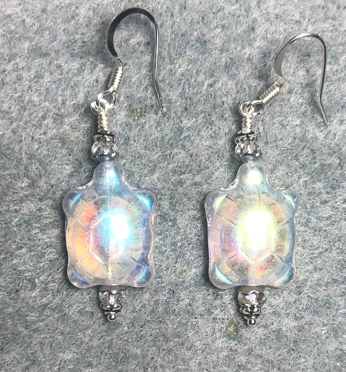 Iridescent white Czech glass turtle bead earrings adorned with clear Chinese crystal beads.