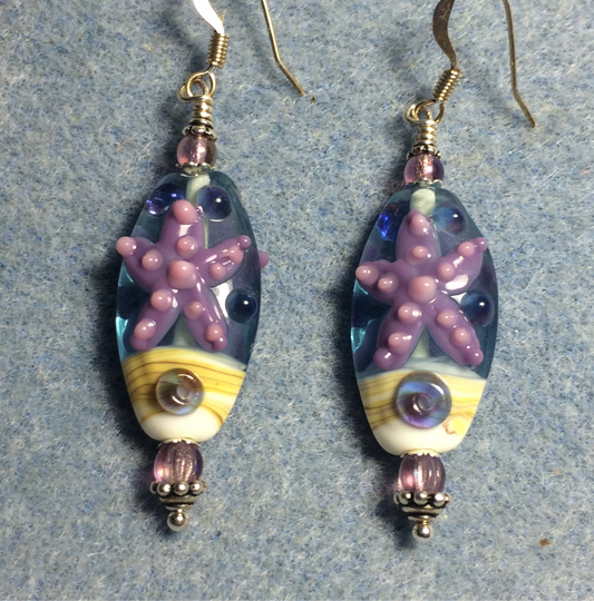 Blue, tan, and lavender lamp work starfish bead earrings adorned with lavender Czech glass beads.