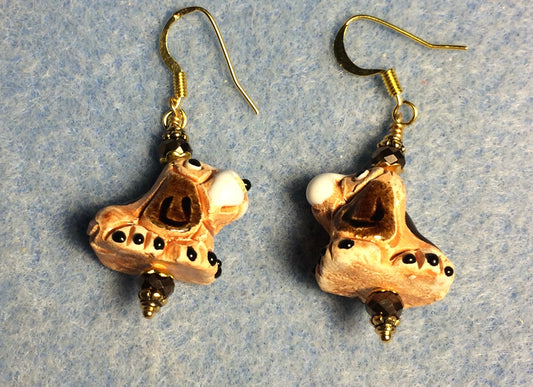 Small tan, brown, and white ceramic hound dog bead earrings adorned with brown Chinese crystal beads.