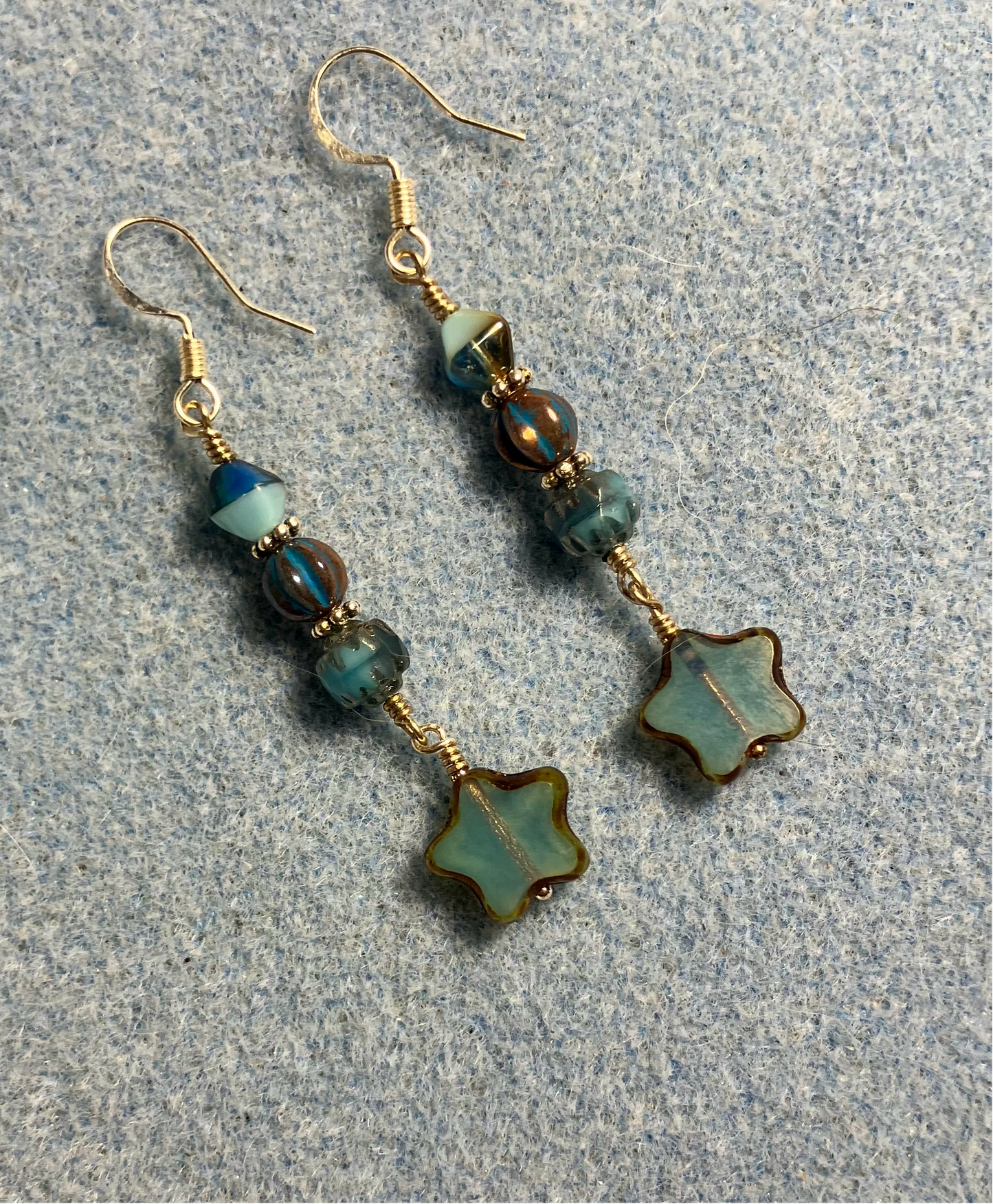 Small light turquoise Czech glass star bead earrings adorned with turquoise and tan Czech glass beads.