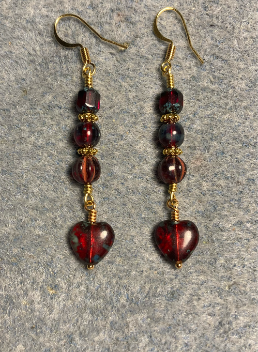 Small translucent ruby red Picasso Czech glass heart bead earrings adorned with ruby red Picasso Czech glass beads.