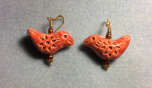 Large dark orange ceramic songbird bead earrings adorned with orange Czech glass beads.