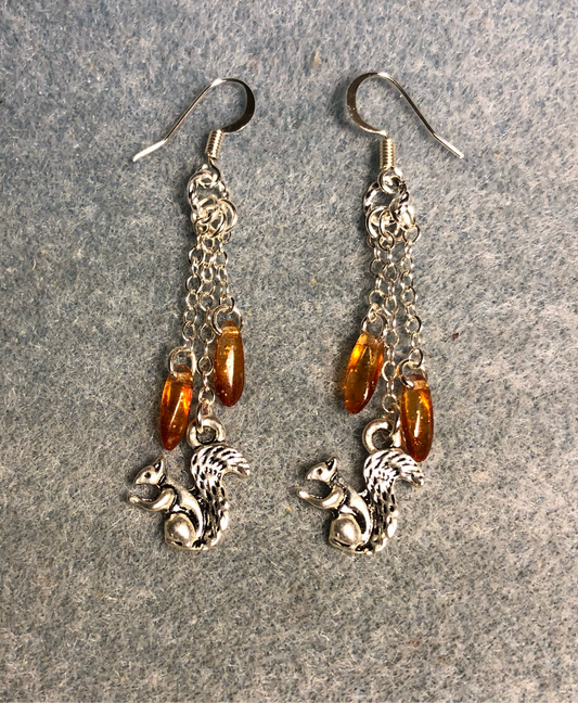 Small silver squirrel charm earrings attached to silver chain and adorned with small amber Czech glass dagger beads