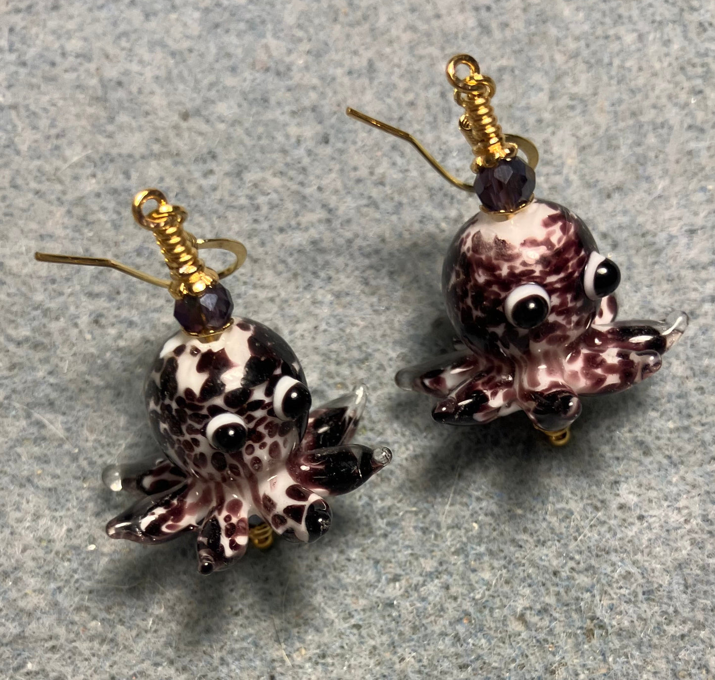 Dark purple and white mottled lamp work octopus bead earrings adorned with dark purple Chinese crystal beads.