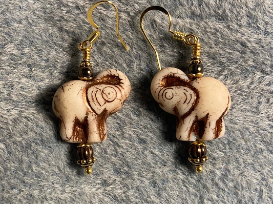 Off white (with brown inlay) Czech glass elephant bead earrings adorned with brown Czech glass beads.