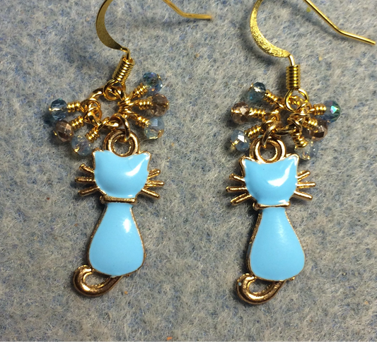 Small light blue and gold enamel cat charm earrings adorned with tiny dangling light blue and gold Chinese crystal beads.