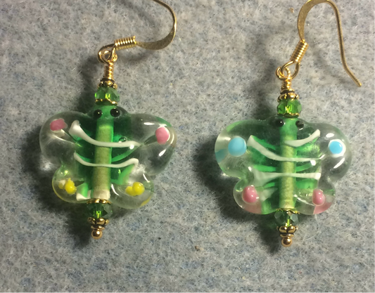 Green and pink lamp work butterfly bead earrings adorned with green Chinese crystal beads.