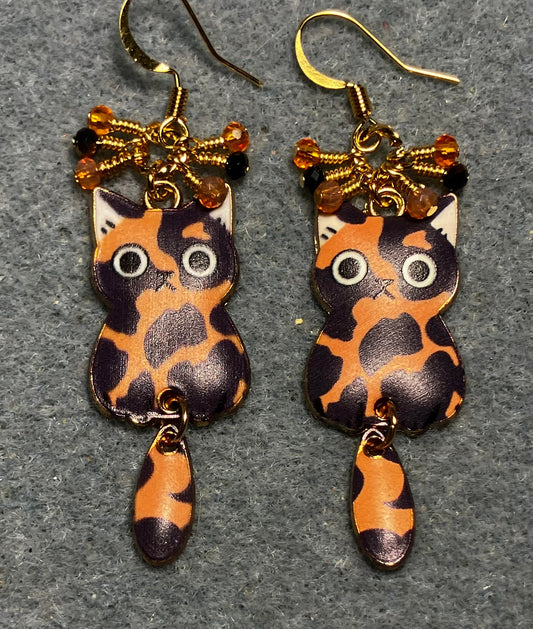 Orange, black, and white enamel calico cat charm earrings adorned with tiny dangling orange and black Chinese crystal beads.