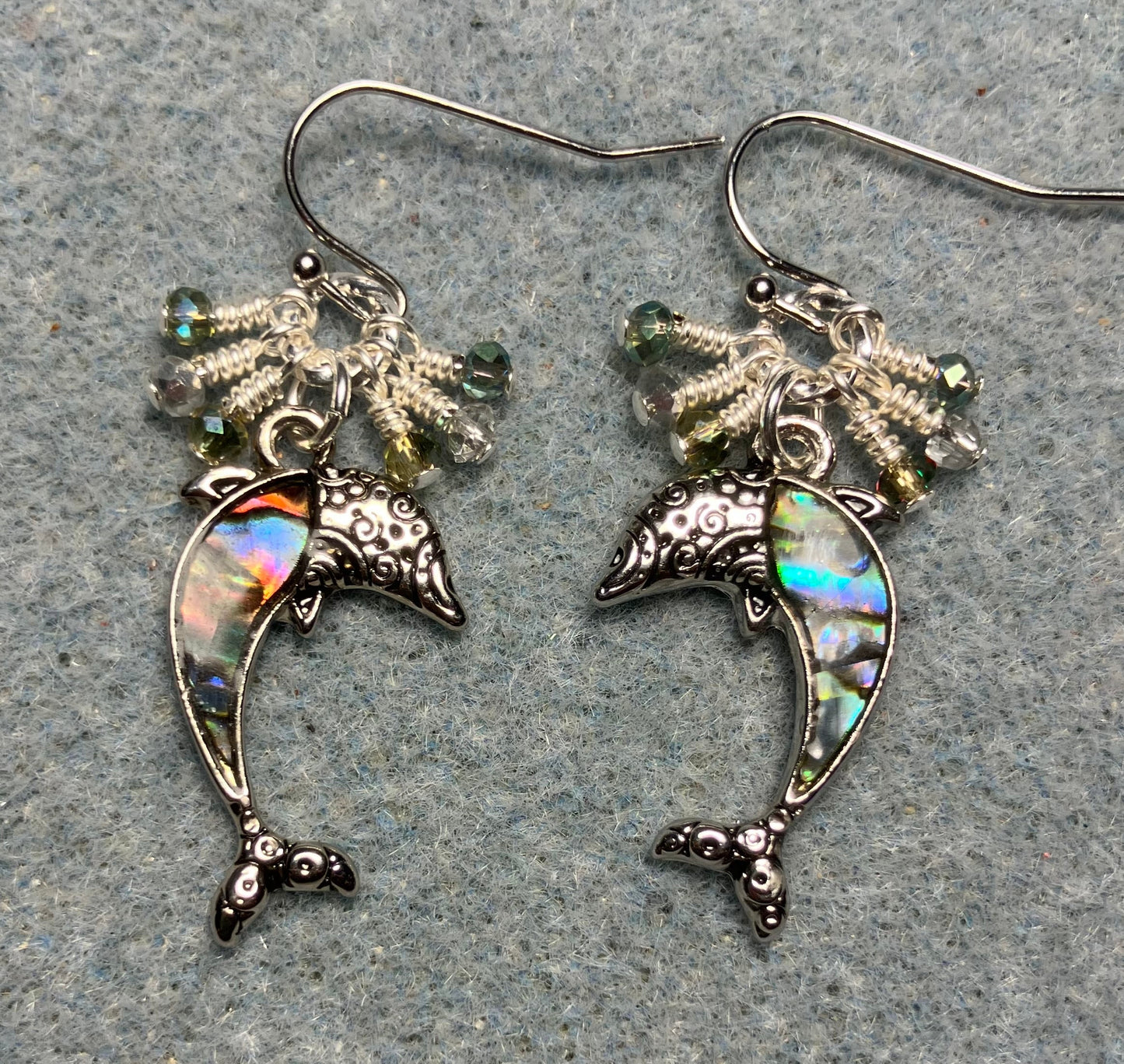 Silver and abalone dolphin charm earrings adorned with tiny dangling green and silver Chinese crystal beads.