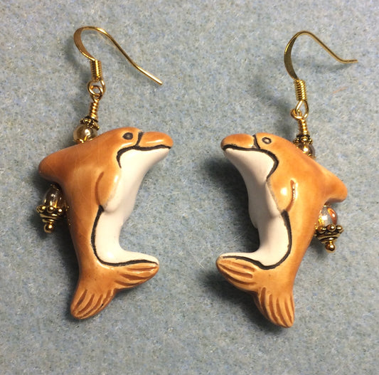 Amber and white ceramic dolphin bead earrings adorned with amber Czech glass beads.