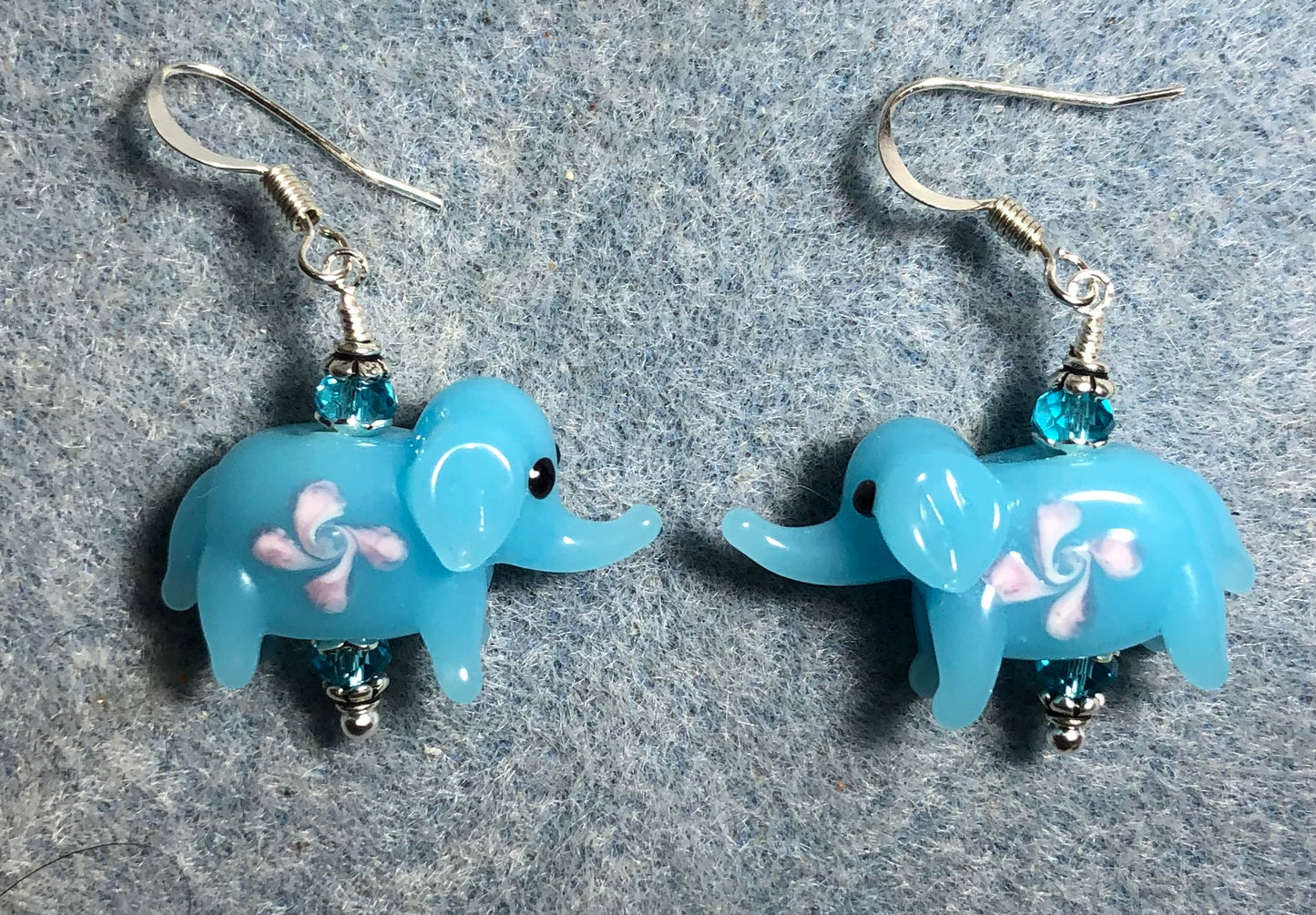 Turquoise and pink lamp work elephant bead earrings adorned with turquoise Chinese crystal beads.