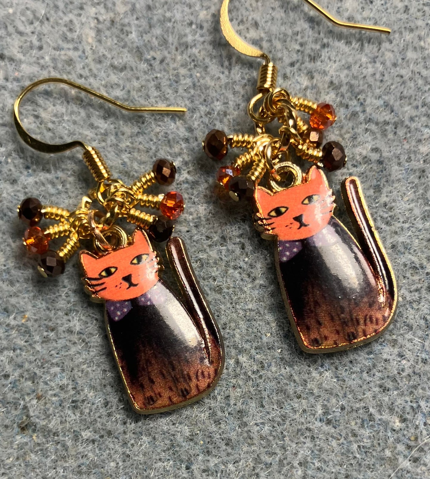 Brown and orange enamel cat charm earrings adorned with tiny dangling brown and orange Chinese crystal beads.