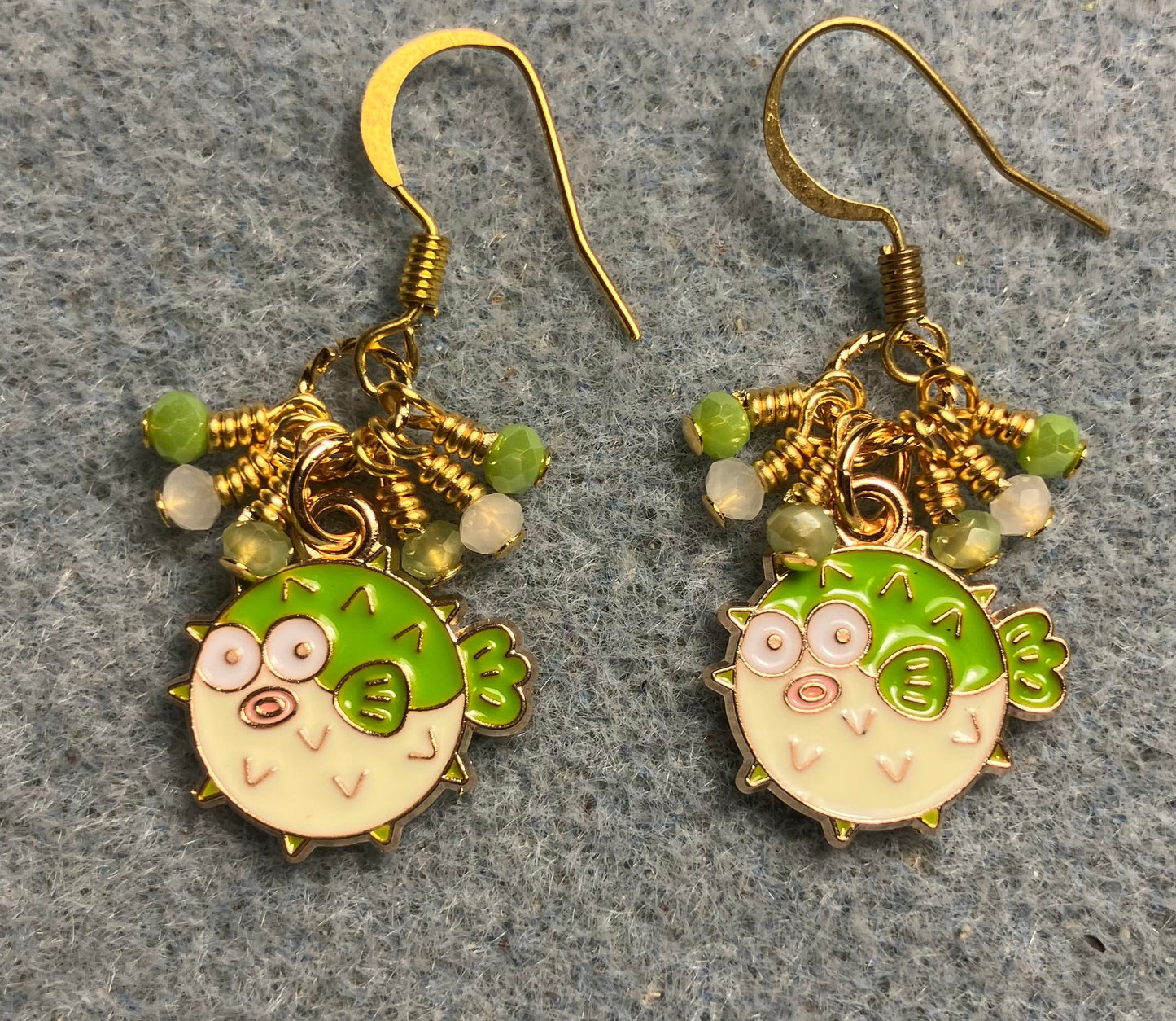 Small lime green enamel blowfish charm earrings adorned with tiny dangling lime green and white Chinese crystal beads.