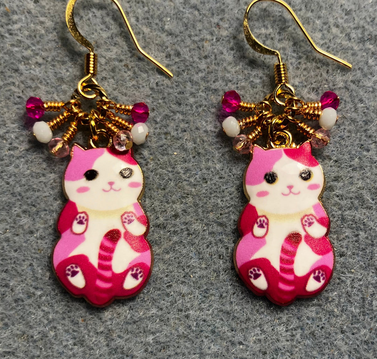 Hot pink, light pink, and white enamel cat charm earrings adorned with tiny dangling hot pink, light pink, and white Chinese crystal beads.