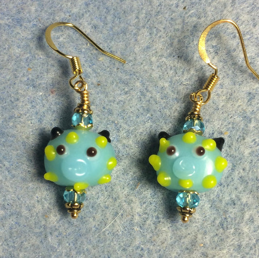 Small turquoise and yellow lamp work pig bead earrings adorned with turquoise Chinese crystal beads.