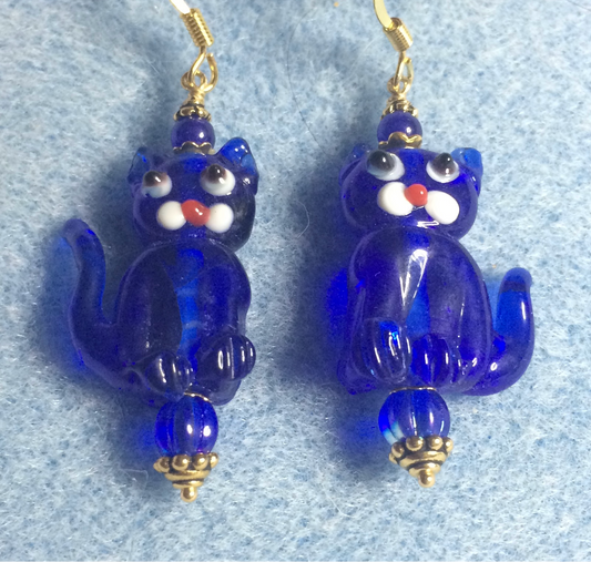 Translucent bright blue lamp work cat bead earrings adorned with bright blue Czech glass beads.