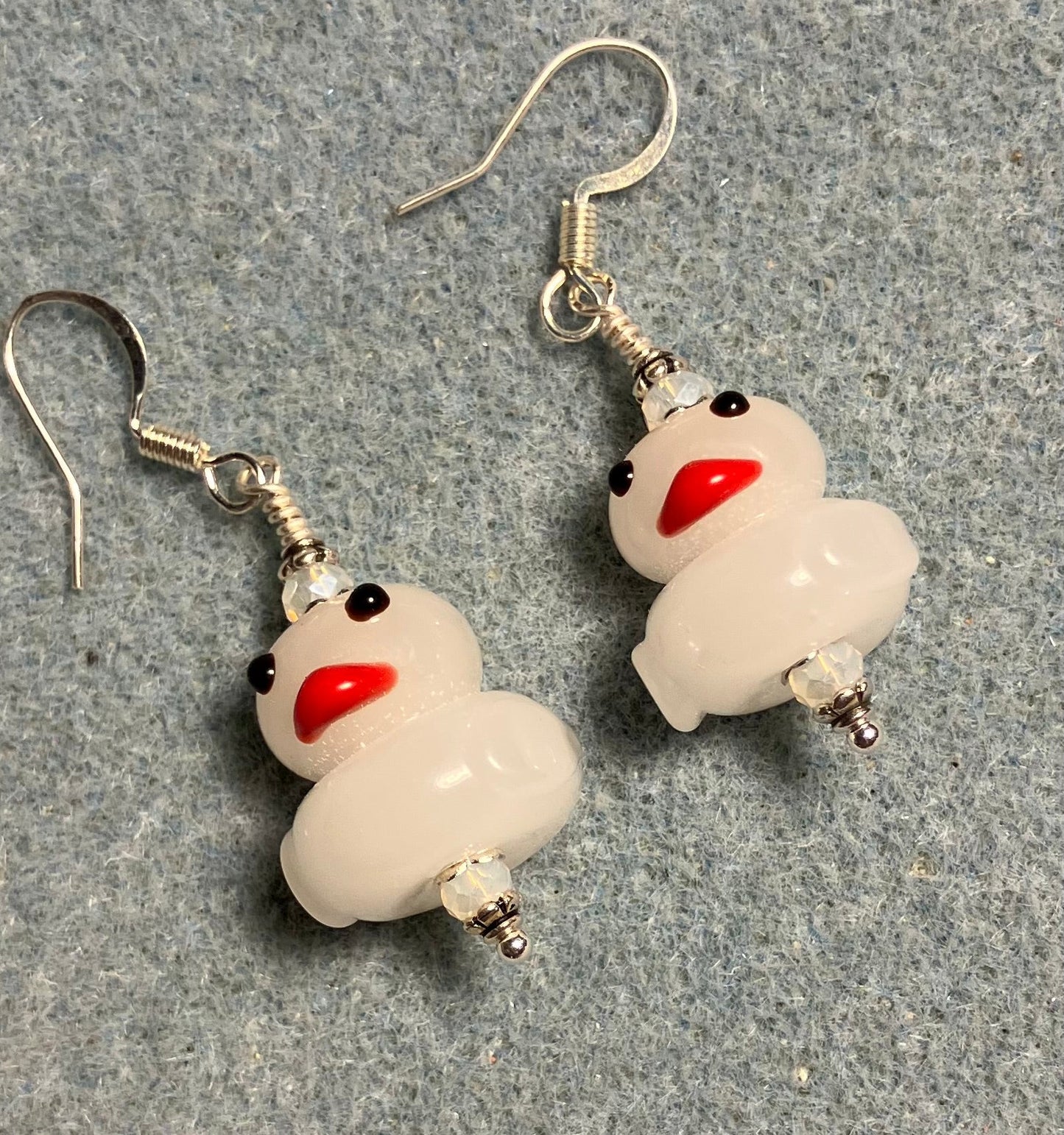 Opaque white lamp work duck bead earrings adorned with white Chinese crystal beads.