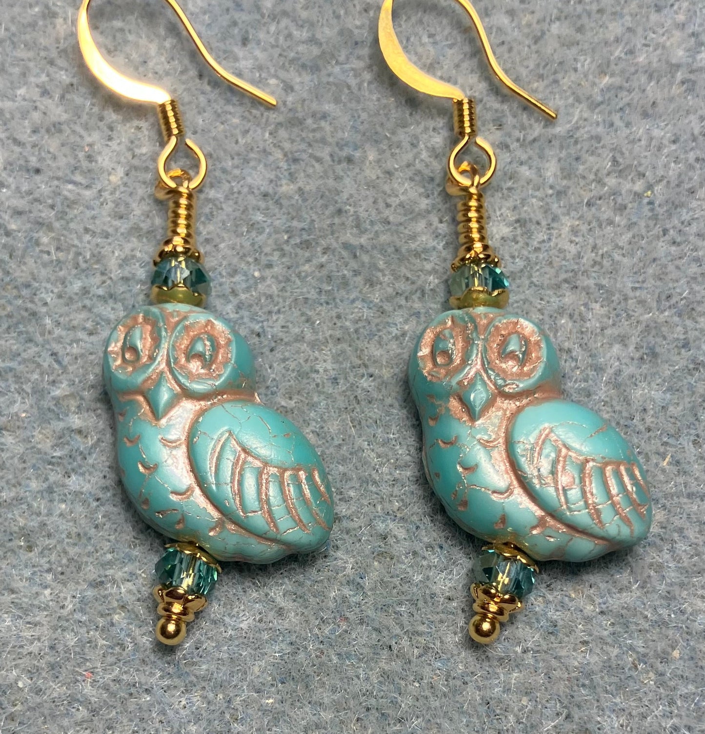 Turquoise (with copper inlay) fancy Czech glass owl bead earrings adorned with turquoise Chinese crystal beads.